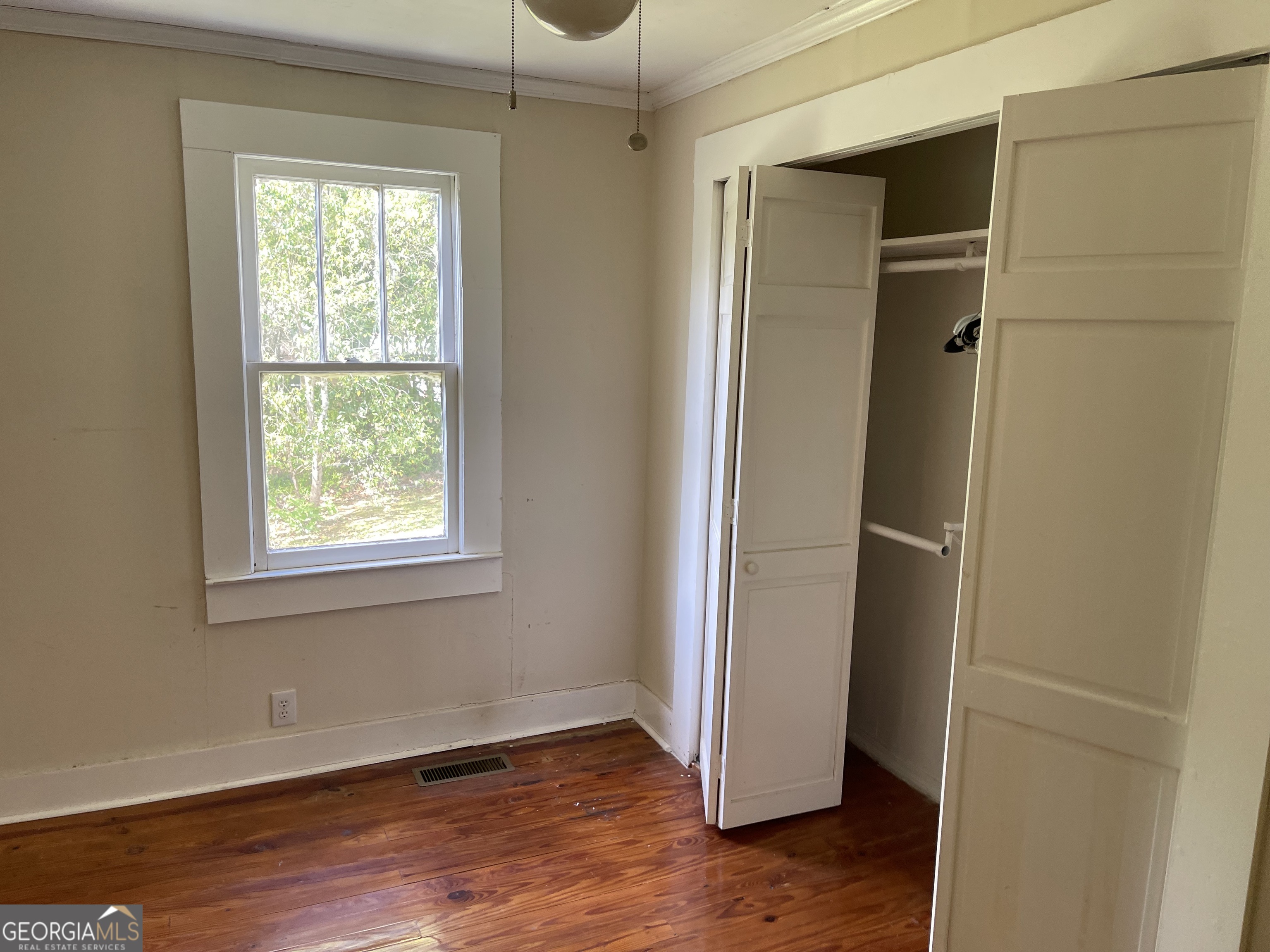 6505 23rd Avenue Valley, AL 36854 - Photo 15 of 49 a view of an empty room with wooden floor and a window