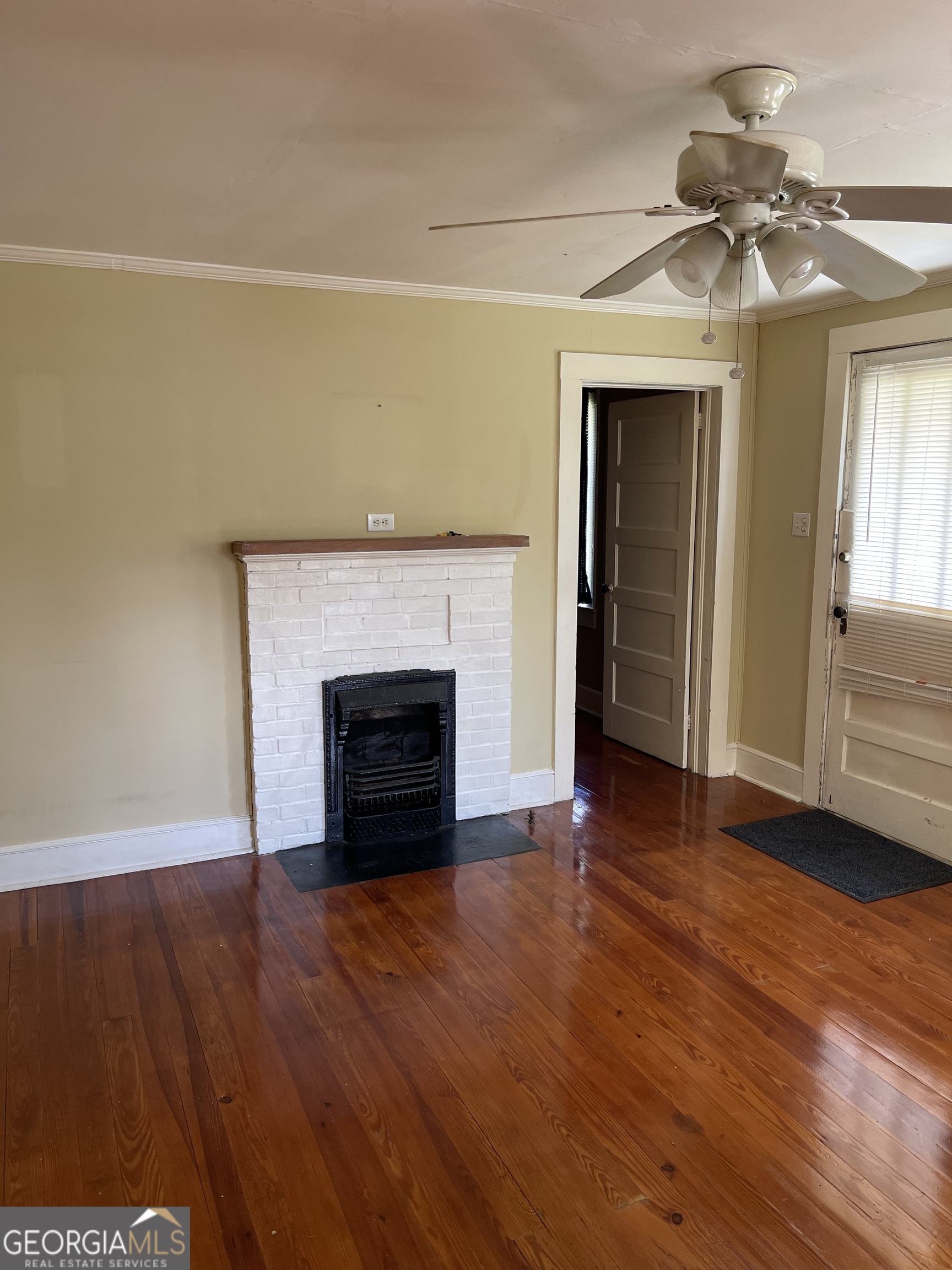 6505 23rd Avenue Valley, AL 36854 - Photo 26 of 49 a view of an empty room with wooden floor fireplace and a window
