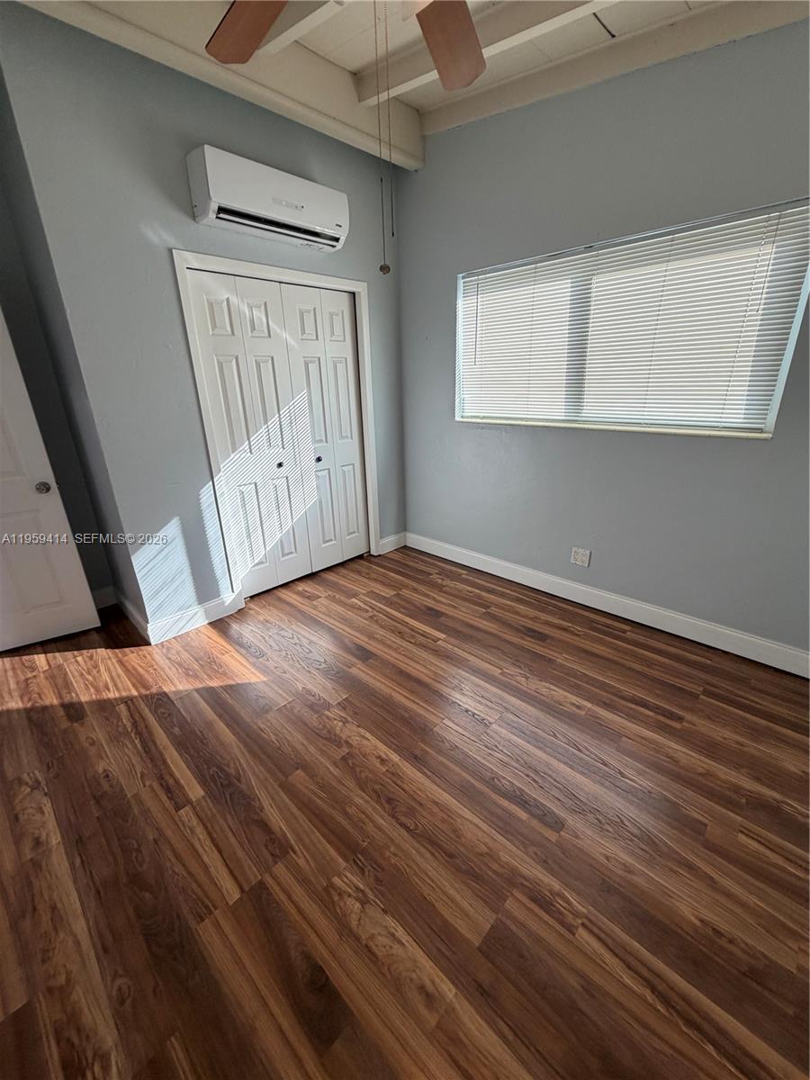 4210 Southwest 10th Street Plantation, FL 33317 - Photo 11 of 19 a view of an empty room with wooden floor and a window