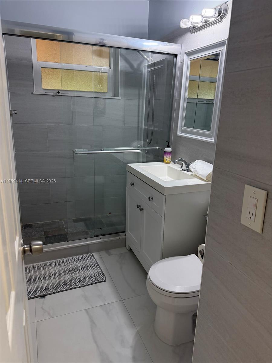 4210 Southwest 10th Street Plantation, FL 33317 - Photo 12 of 19 a bathroom with a sink a toilet and shower