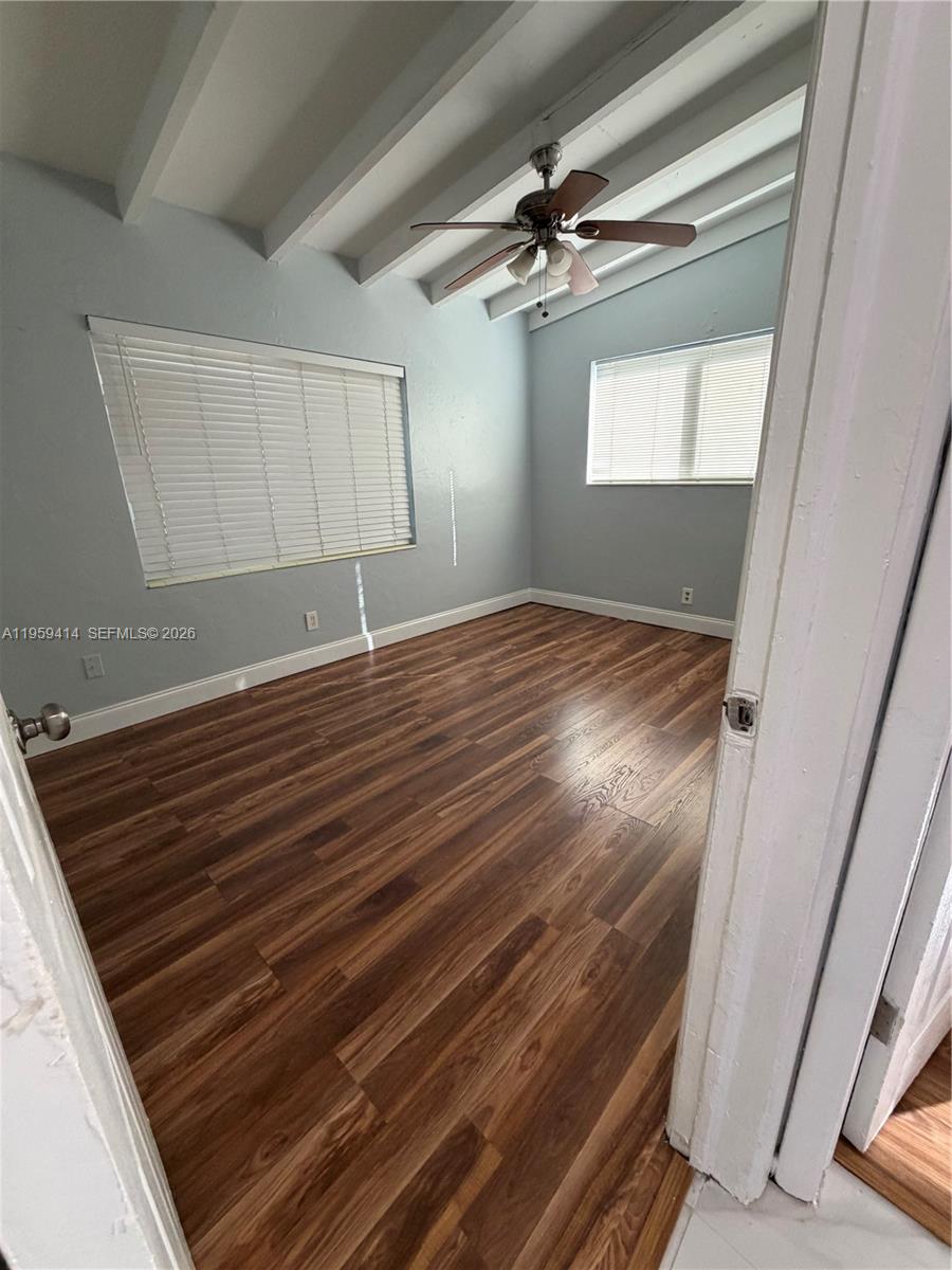 4210 Southwest 10th Street Plantation, FL 33317 - Photo 13 of 19 a view of empty room with window and wooden floor