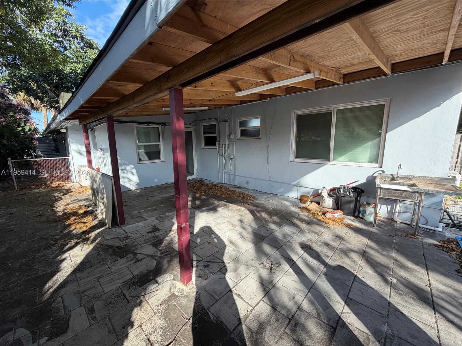 4210 Southwest 10th Street Plantation, FL 33317 - Photo 16 of 19 a view of a backyard with table and chairs under an umbrella