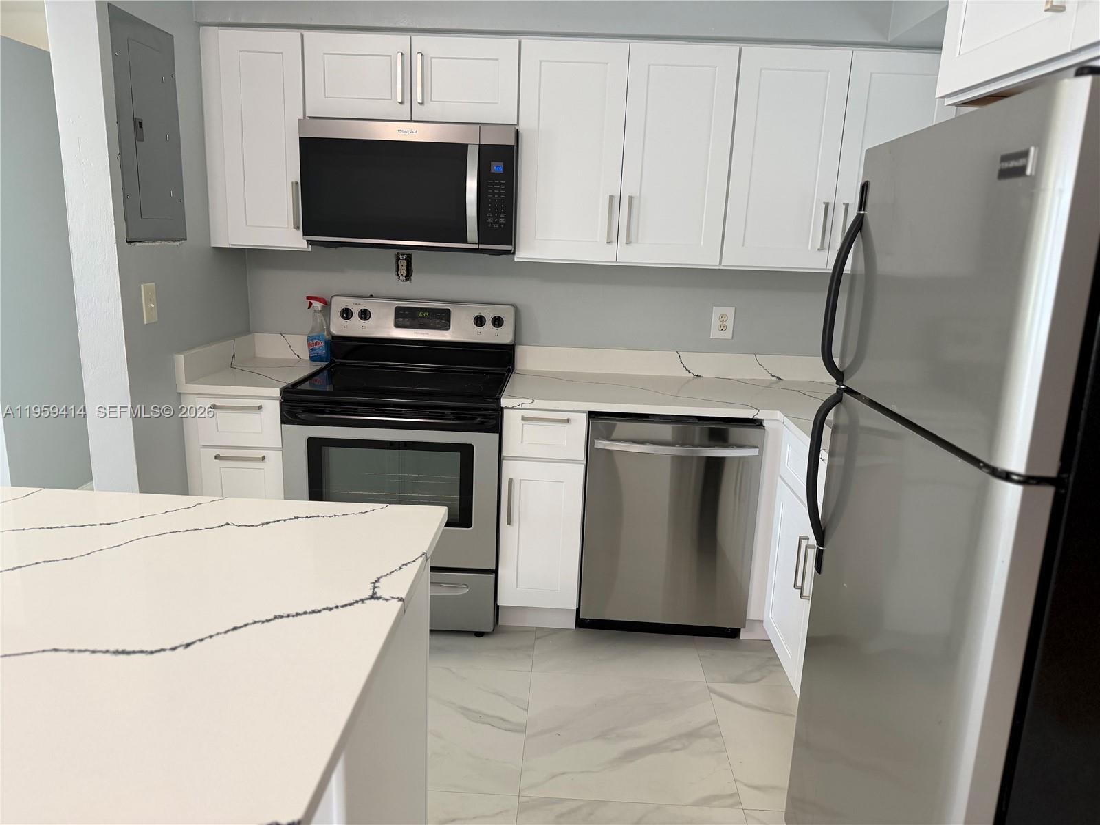 4210 Southwest 10th Street Plantation, FL 33317 - Photo 5 of 19 a kitchen with a refrigerator stove and microwave