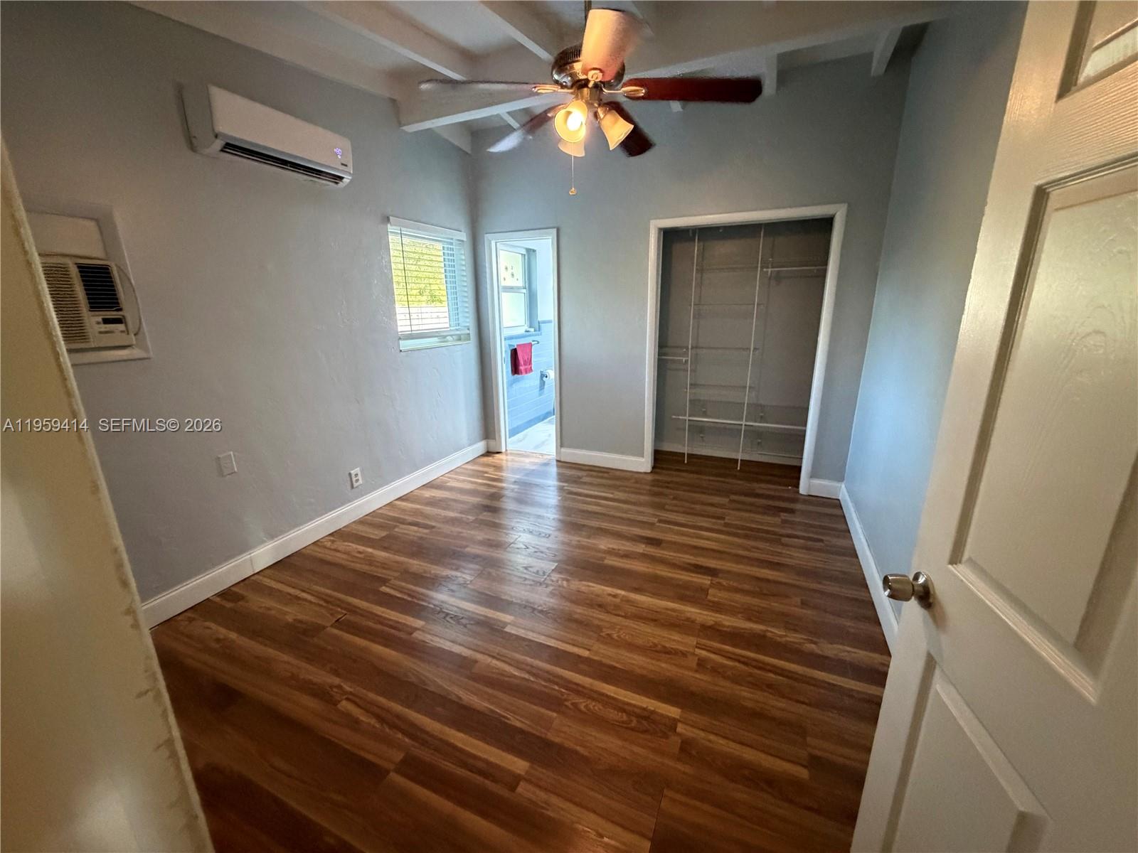 4210 Southwest 10th Street Plantation, FL 33317 - Photo 8 of 19 a view of an empty room with wooden floor and a ceiling fan