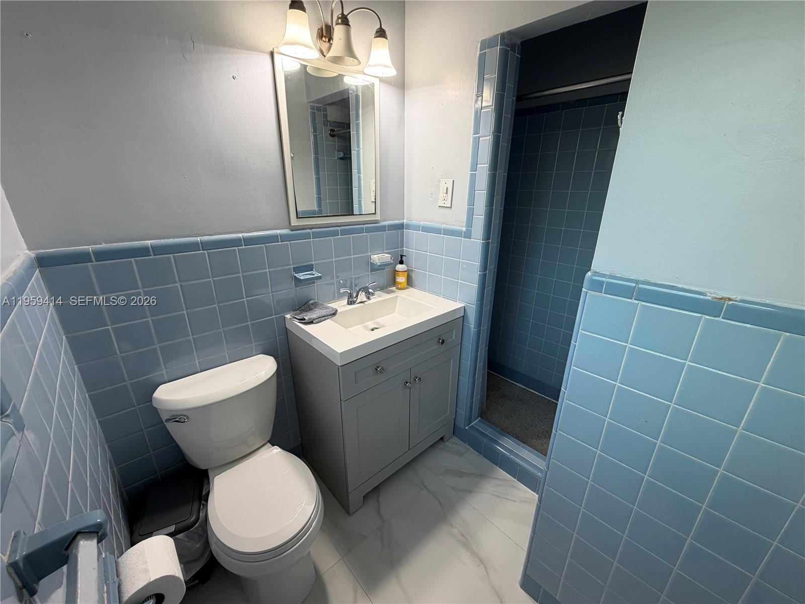 4210 Southwest 10th Street Plantation, FL 33317 - Photo 9 of 19 a bathroom with a toilet sink and mirror