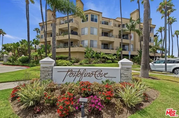 a front view of a multi story residential apartment building with a yard