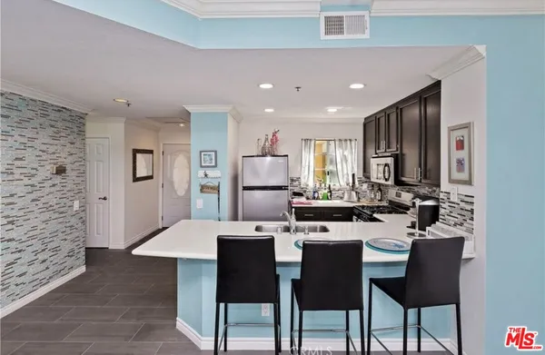 a large kitchen with a table and chairs