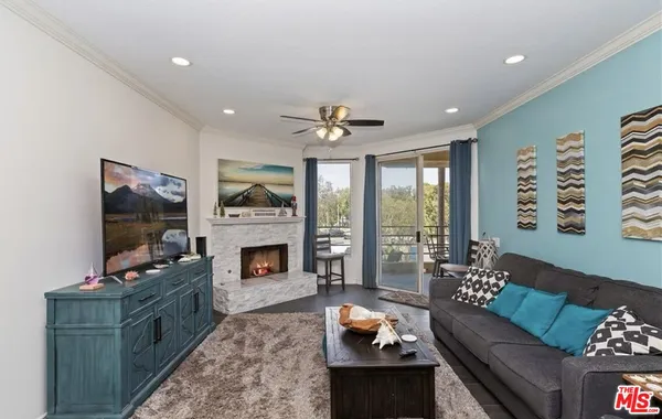a living room with furniture a fireplace and a flat screen tv