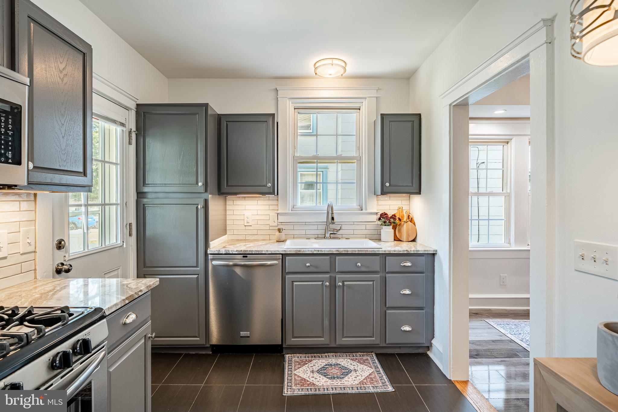 240 Ballymore Road Springfield, PA 19064 - Photo 14 of 33 a kitchen with stainless steel appliances granite countertop a stove and a sink