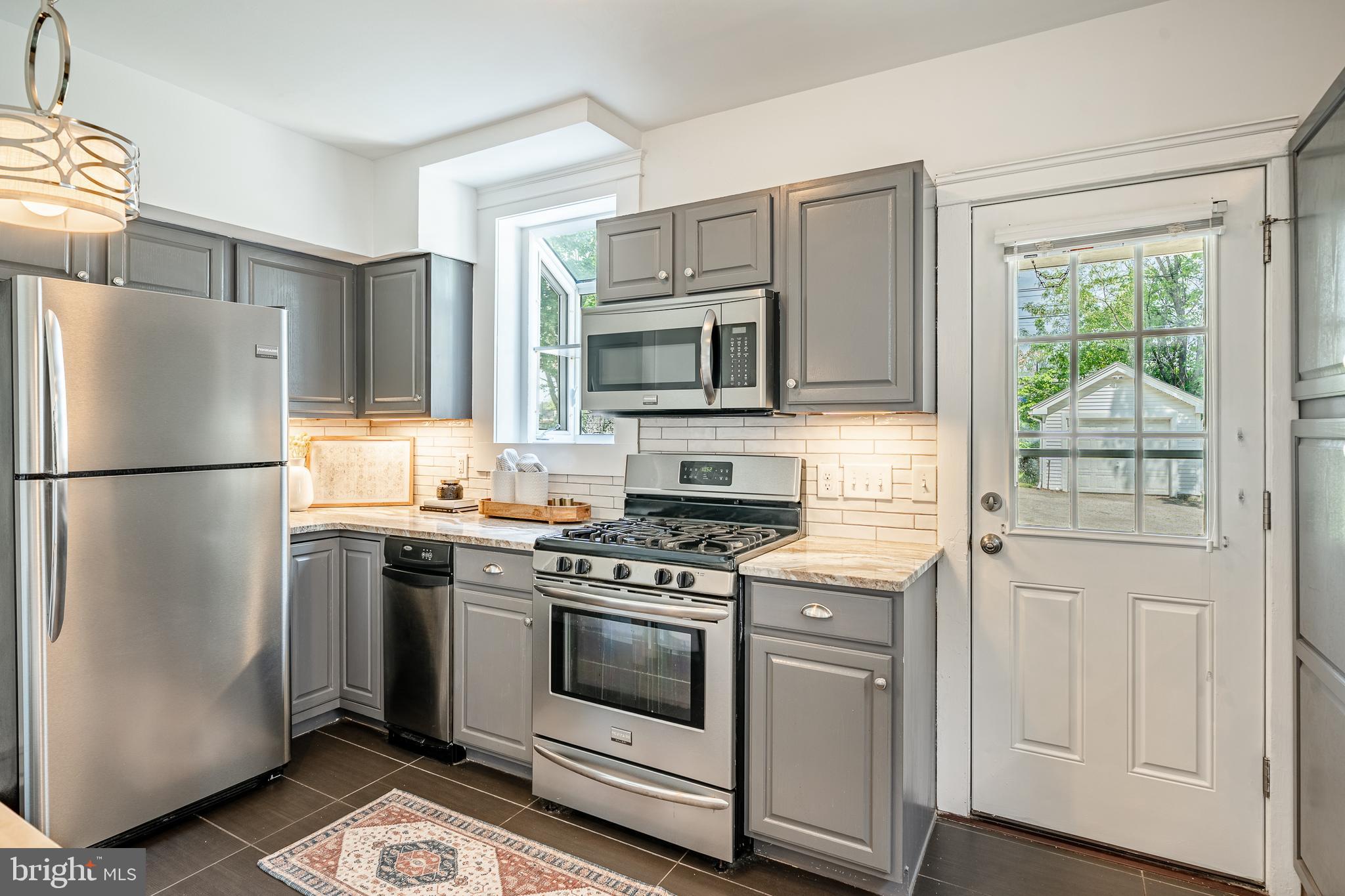 240 Ballymore Road Springfield, PA 19064 - Photo 16 of 33 a kitchen with cabinets stainless steel appliances and wooden floor