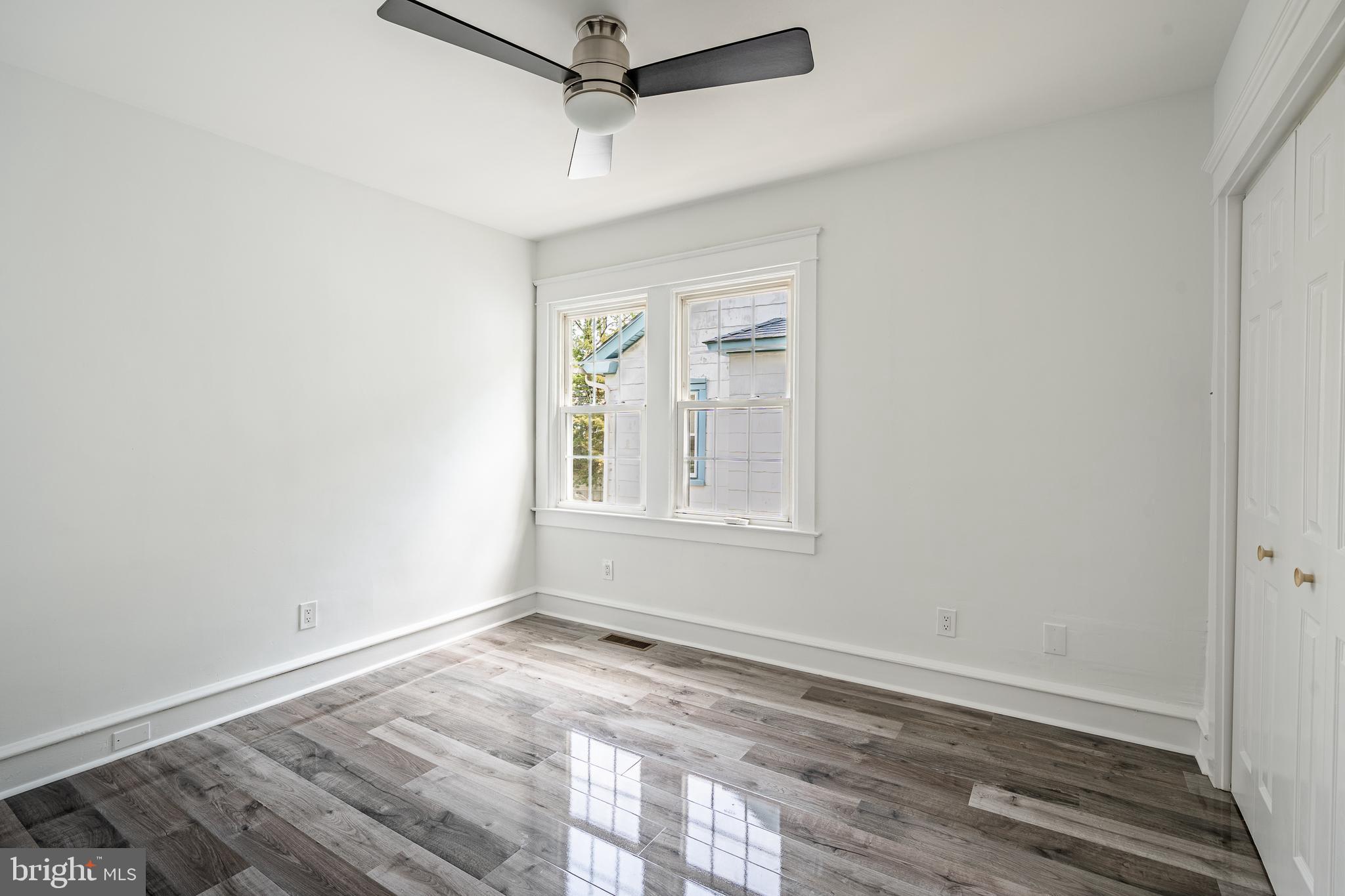 240 Ballymore Road Springfield, PA 19064 - Photo 21 of 33 an empty room with wooden floor fan and windows