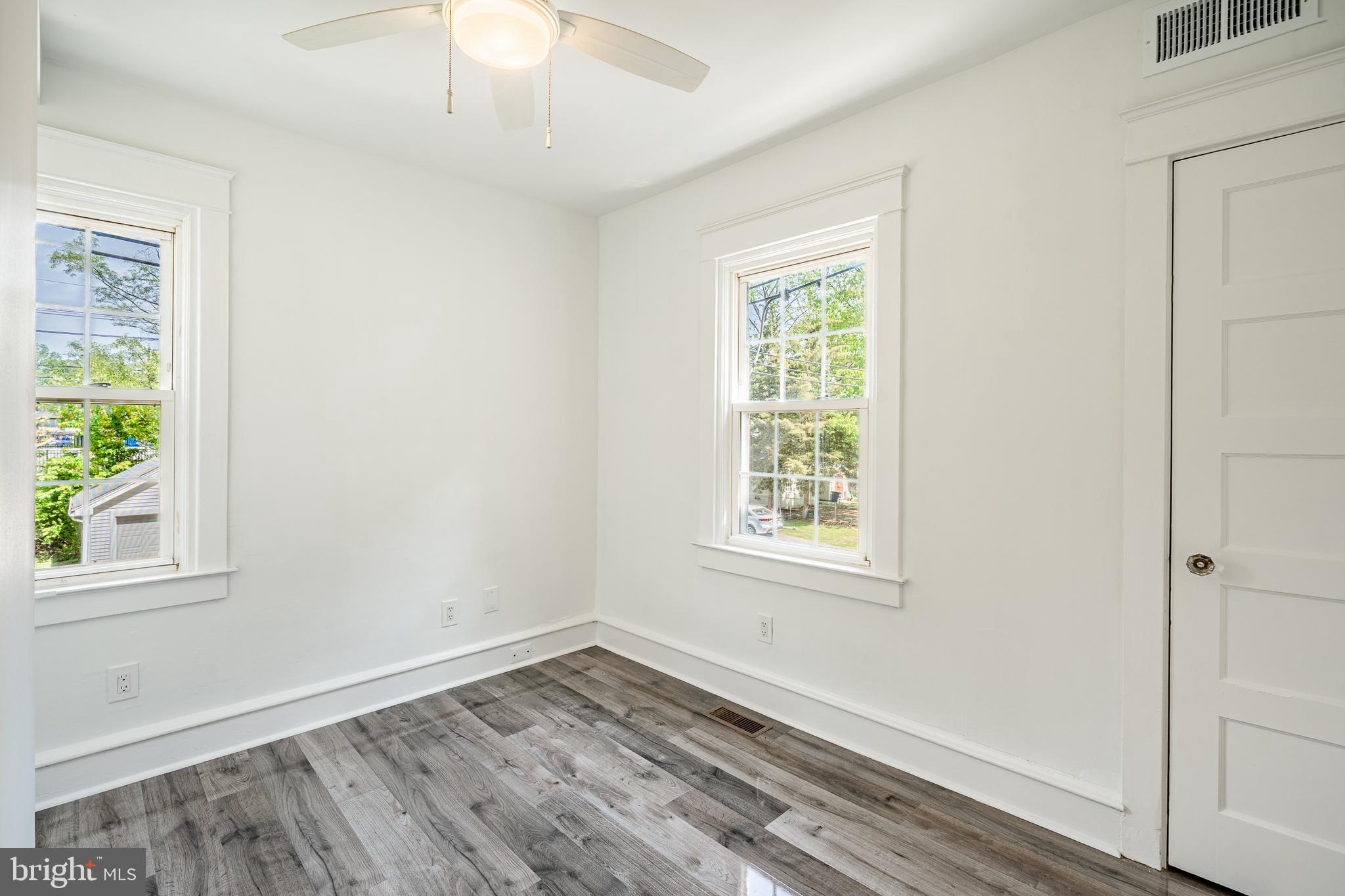 240 Ballymore Road Springfield, PA 19064 - Photo 22 of 33 an empty room with wooden floor and windows