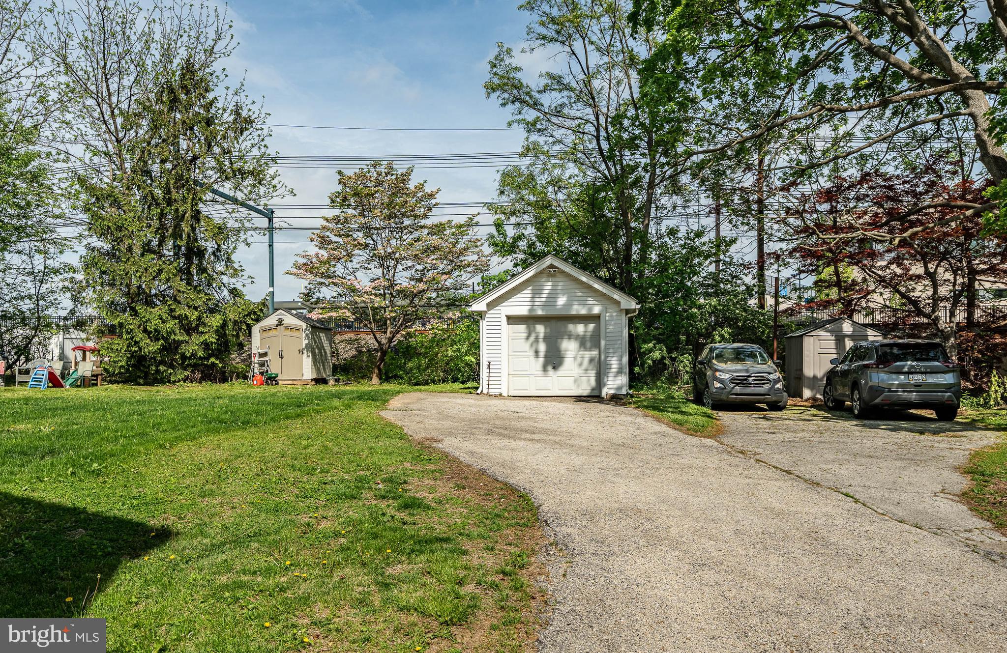 240 Ballymore Road Springfield, PA 19064 - Photo 24 of 33 a front view of a house with a yard and garage