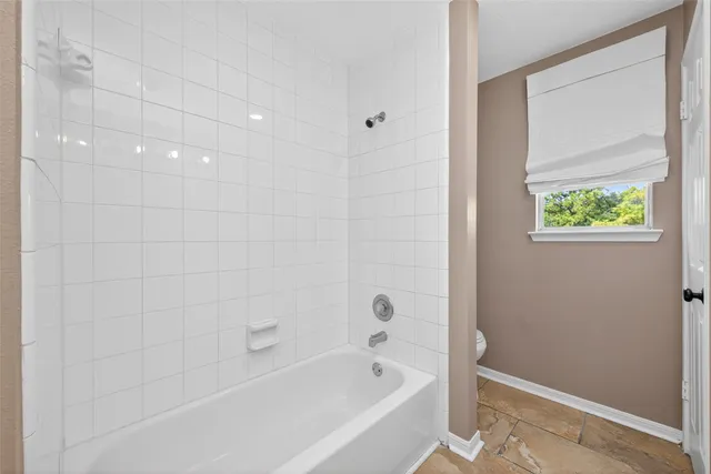 a bathroom with a bathtub and shower