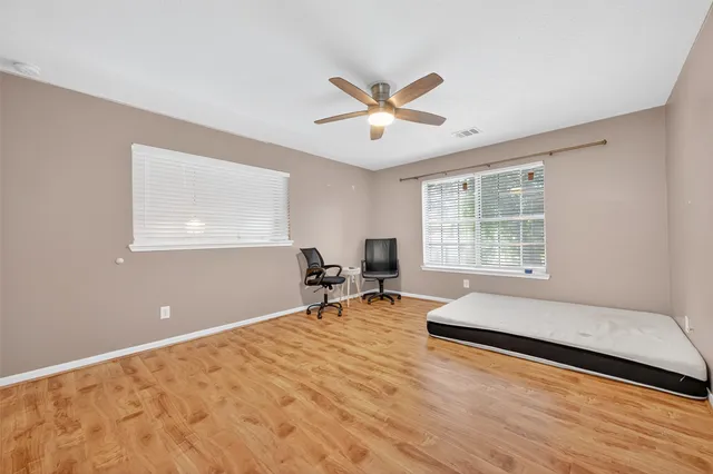 a spacious bedroom with a bed and a window