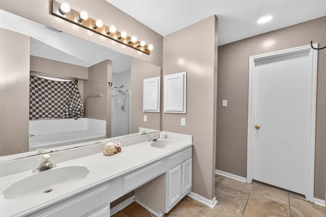 a bathroom with a sink double vanity and a mirror