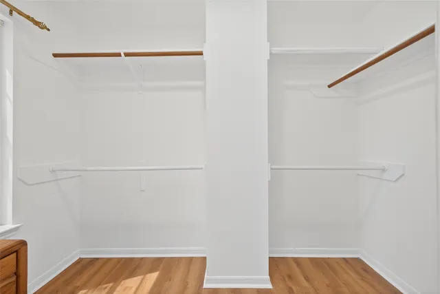 a view of walk in closet with clothes