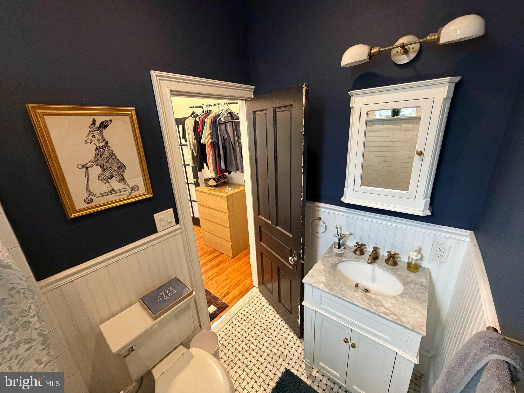 815 South 49th Street Philadelphia, PA 19143 - Photo 22 of 72 a bathroom with a sink mirror vanity and toilet