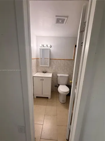 a bathroom with a sink a toilet and mirror