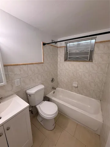 a bathroom with a toilet a sink and bathtub
