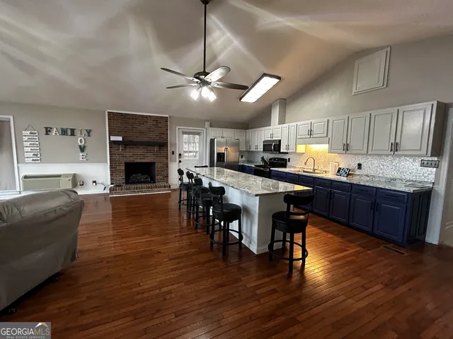 a kitchen with a table chairs refrigerator and microwave