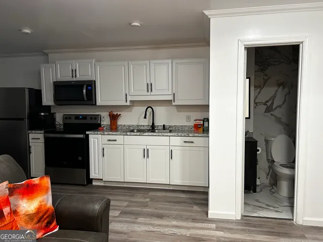 a kitchen with stainless steel appliances granite countertop a refrigerator sink and cabinets