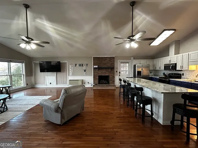 a living room with fireplace furniture and a wooden floor