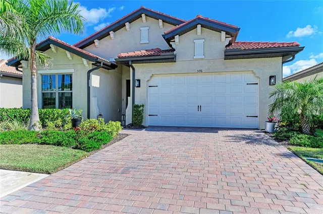 a dining room with furniture a chandelier and window