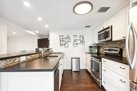 a kitchen with a sink stove and microwave