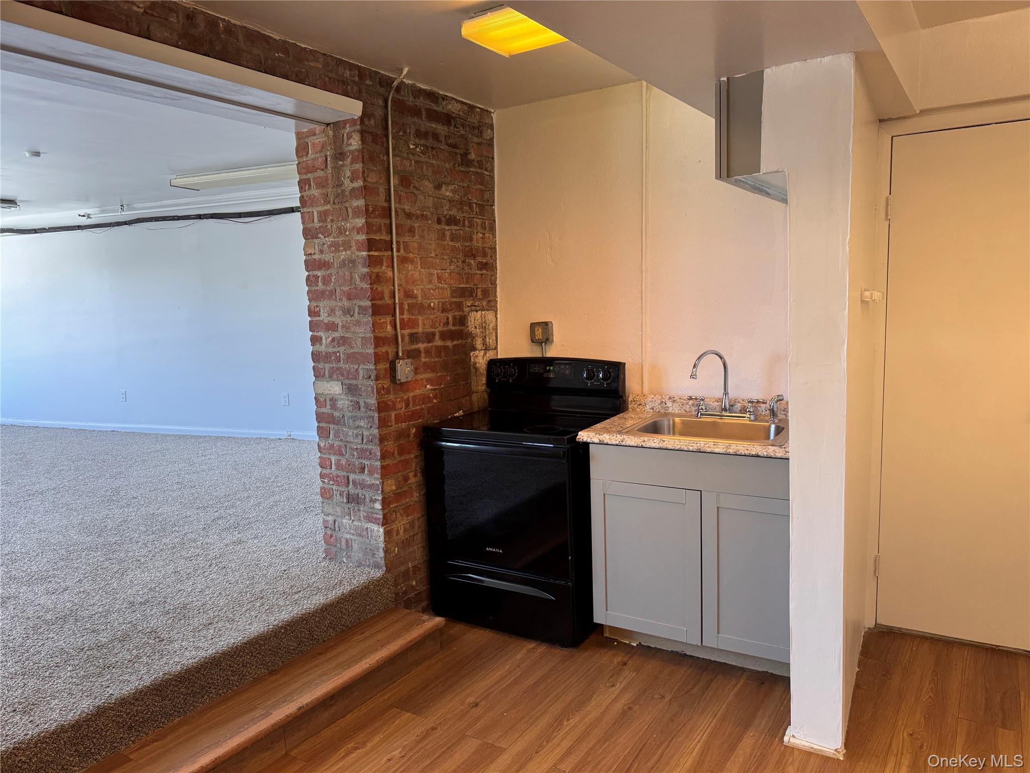 175 Main Street, Unit 2R Ossining, NY 10562 - Photo 3 of 22 Electric range and sink with cabinets below.
