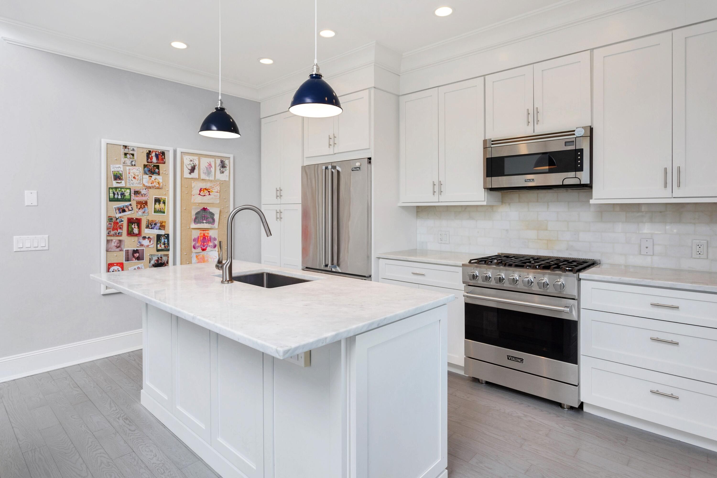 71 Rowayton Avenue, Unit 7 Rowayton, CT 06853 - Photo 12 of 31 a kitchen with stainless steel appliances granite countertop a white stove top oven a sink dishwasher and a refrigerator with wooden floor