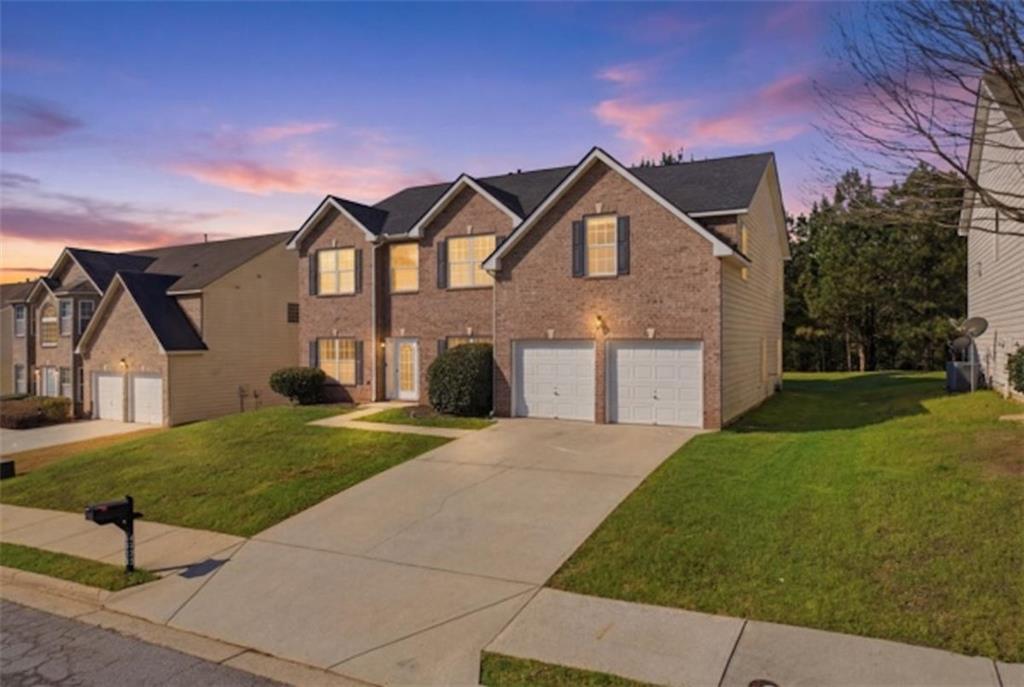 a front view of a house with a yard and garage