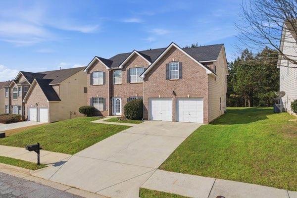 4925 Locherby Drive Fairburn, GA 30213 - Photo 2 of 85 a front view of a house with a yard and garage