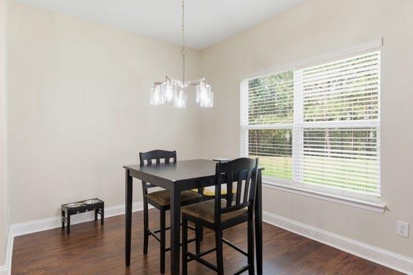 4925 Locherby Drive Fairburn, GA 30213 - Photo 25 of 85 a view of a dining room with furniture wooden floor and chandelier