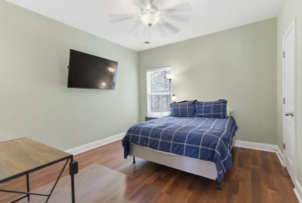 4925 Locherby Drive Fairburn, GA 30213 - Photo 44 of 85 a bedroom with a bed and a flat screen tv