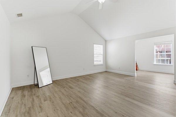 4925 Locherby Drive Fairburn, GA 30213 - Photo 60 of 85 an empty room with wooden floor and windows