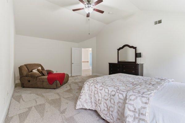 4925 Locherby Drive Fairburn, GA 30213 - Photo 63 of 85 a bedroom with a bed and a chandelier