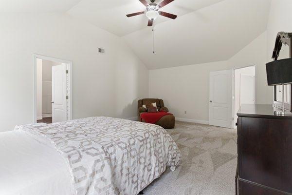 4925 Locherby Drive Fairburn, GA 30213 - Photo 69 of 85 a bedroom with a bed and black ceiling fan