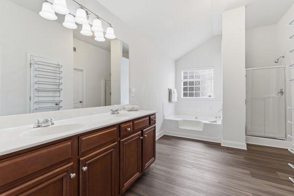 4925 Locherby Drive Fairburn, GA 30213 - Photo 72 of 85 a spacious bathroom with a granite countertop double vanity sink a mirror and a bathtub