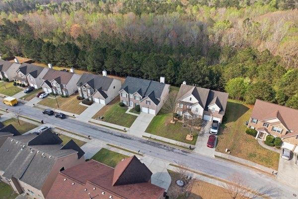 4925 Locherby Drive Fairburn, GA 30213 - Photo 84 of 85 an aerial view of a house with a yard basket ball court and outdoor seating