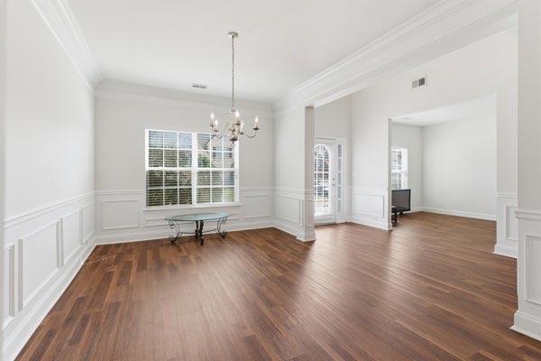 4925 Locherby Drive Fairburn, GA 30213 - Photo 10 of 85 a view of an empty room with wooden floor and a window