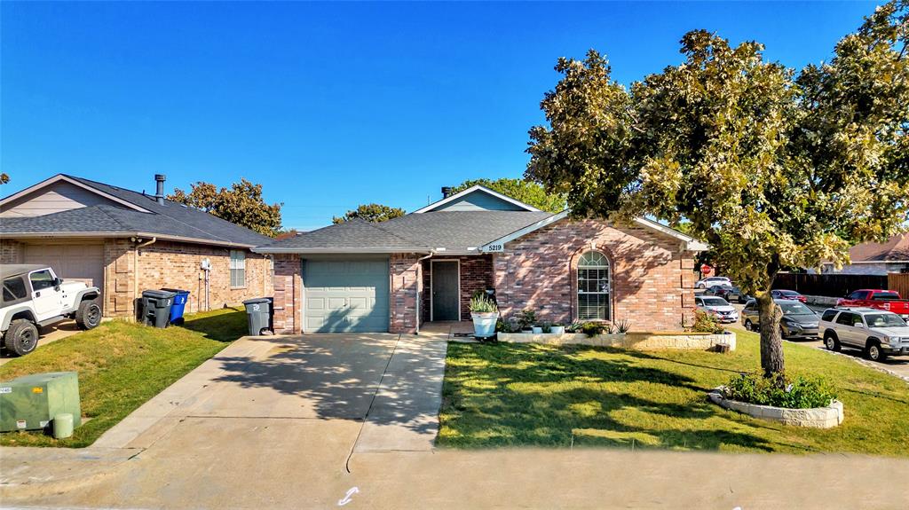 a front view of a house with a yard outdoor seating and a garage