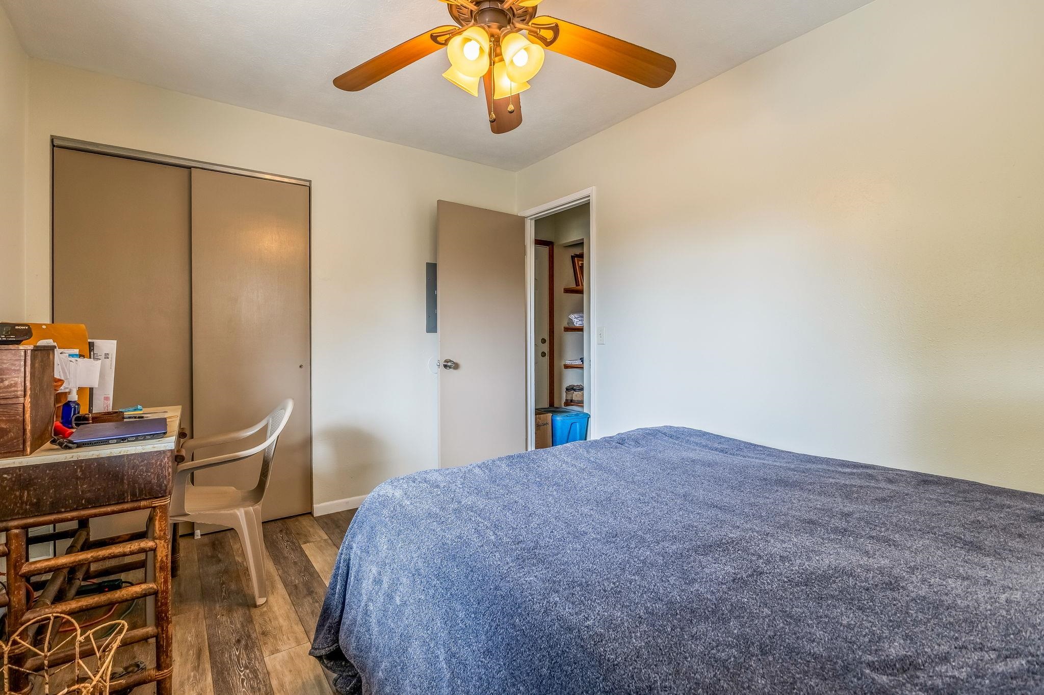 1156 South Kihei Road Kihei, HI 96753 - Photo 13 of 25 a bedroom with a bed and a chandelier