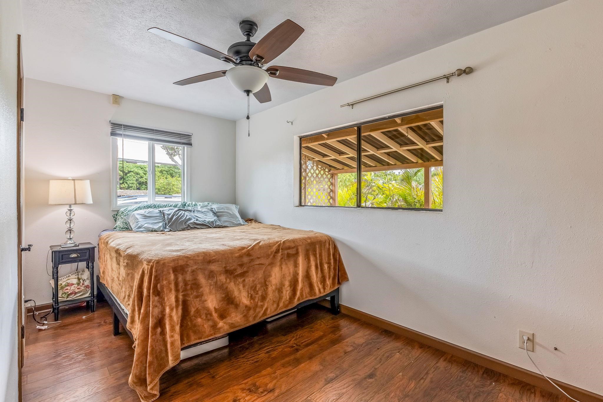 1156 South Kihei Road Kihei, HI 96753 - Photo 18 of 25 a bed sitting in a spacious bedroom next to a window