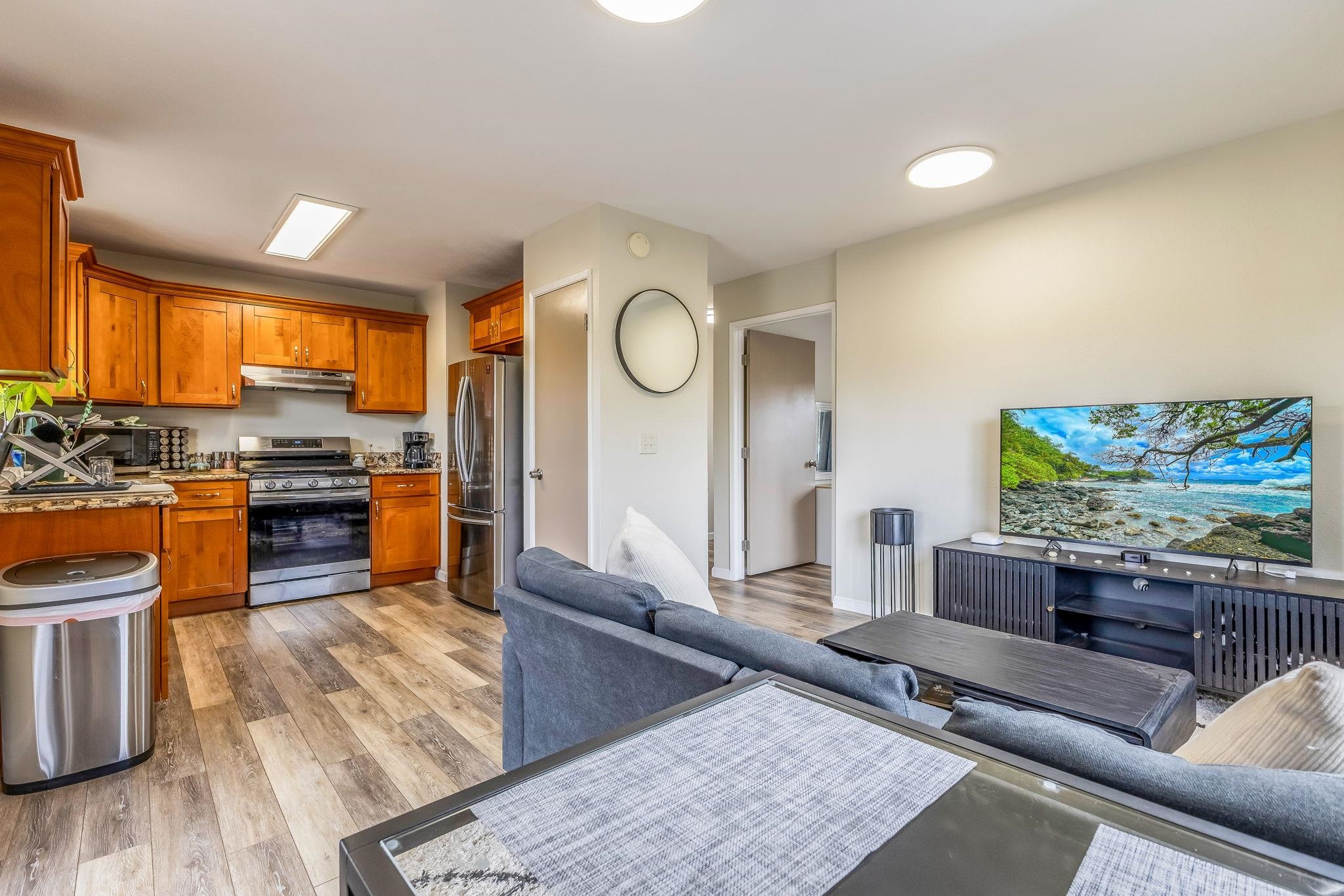 1156 South Kihei Road Kihei, HI 96753 - Photo 3 of 25 a living room with furniture and a flat screen tv