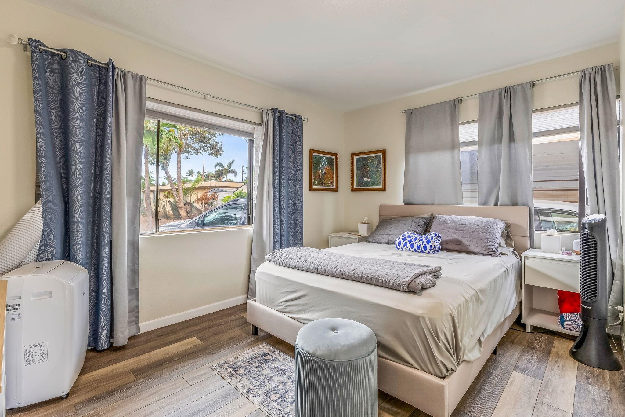 1156 South Kihei Road Kihei, HI 96753 - Photo 4 of 25 a bedroom with a bed and a window with wooden floor