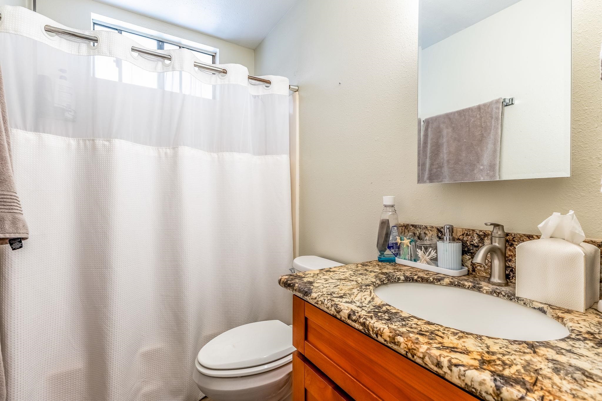1156 South Kihei Road Kihei, HI 96753 - Photo 6 of 25 a bathroom with a granite countertop sink toilet and shower