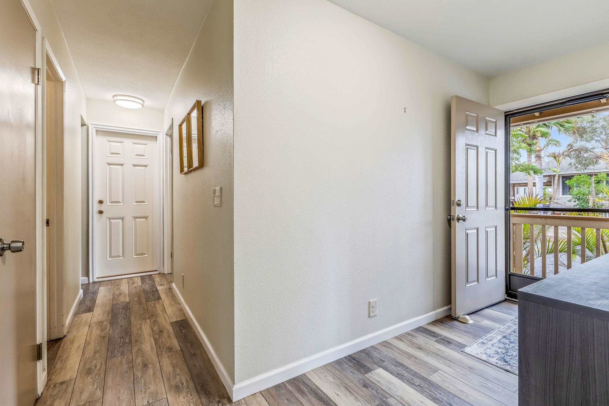 1156 South Kihei Road Kihei, HI 96753 - Photo 7 of 25 a view of a hallway with wooden floor and a window