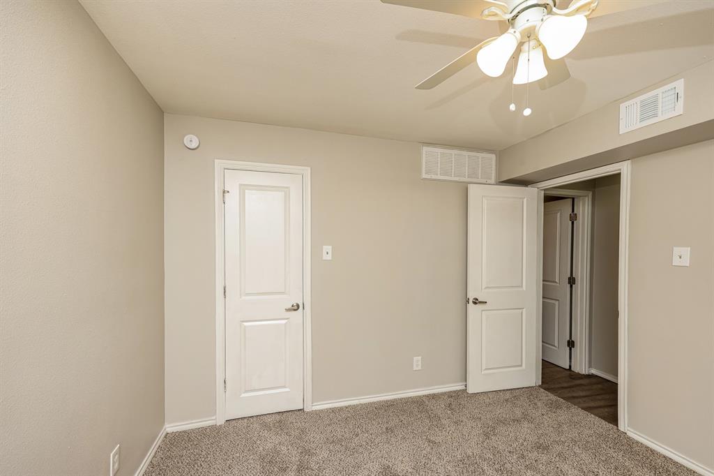 4622 Monarch Street, Unit 202 Dallas, TX 75204 - Photo 11 of 16 Neutral-toned walls complement the carpeted flooring