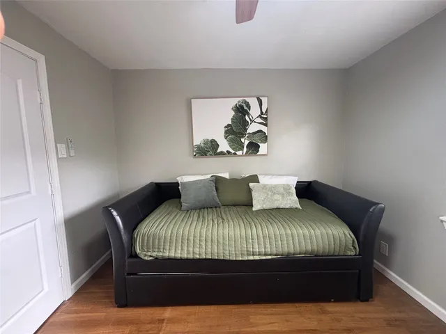 a bedroom with a bed and painting on the wall